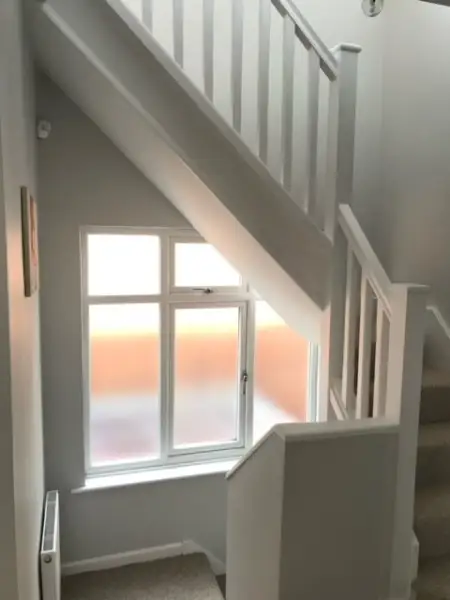 tight staircase cutting across the landing window: Swipe To View More Images